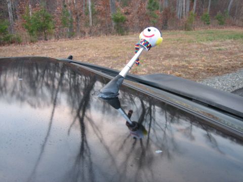 1987 Volkswagen Scirocco - A snowman antenna topper adorns the roof of a black car.