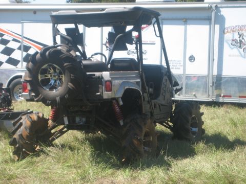 1994 Ford Bronco - Mud bogging ATV with oversized tires and a spare tire on the rear.