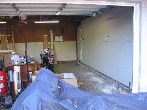 1989 Ford Bronco - Interior view of a garage, showing storage and a covered item in the foreground.