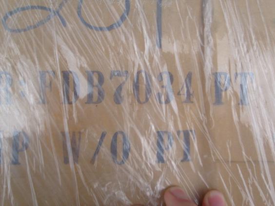 Stenciled part number FDB7034 PT on a shrink-wrapped cardboard parts box