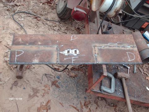 1990 Ford F-150 - Metal plate marked with chalk letters P, B, F, and D, likely for a fabrication project.
