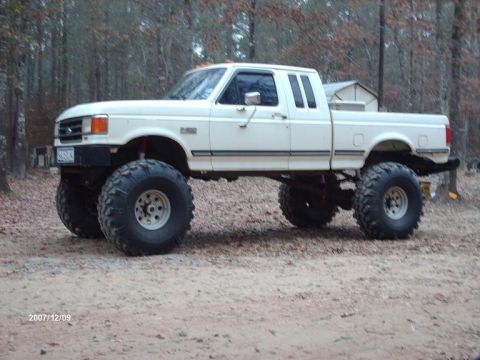 1990 Ford F-150 - This lifted 1990 Ford F-150 pickup truck is equipped with oversized tires for off-road capability.