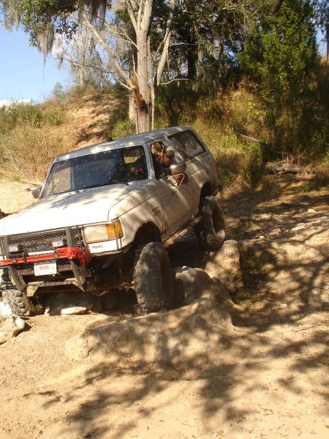1989 Ford Bronco - This 1980s Ford Bronco is shown off-roading on a dirt and rock path.