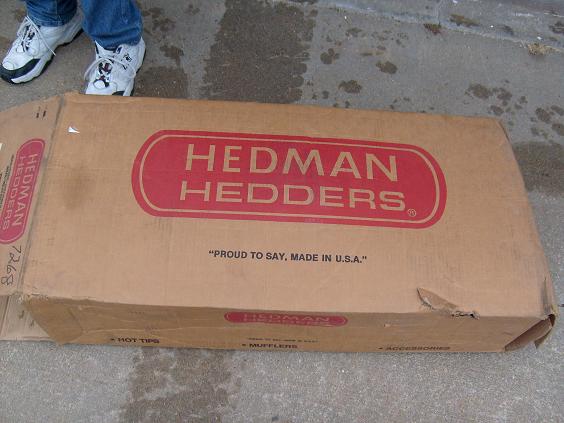 Unopened Hedman Hedders header box with red logo on a concrete driveway