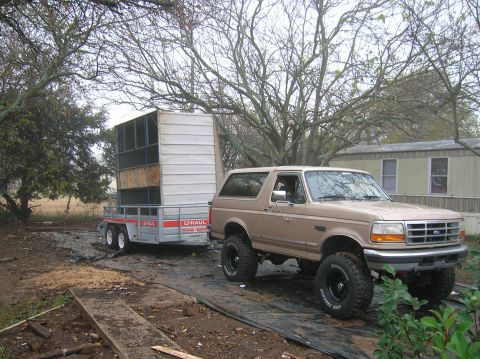 1996 Ford Bronco - A tan 1996 Ford Bronco, equipped with a lifted suspension, is seen towing a U-Haul trailer.