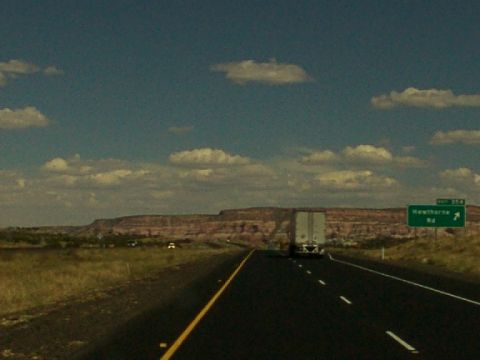 1995 Ford C-350 (Centurion Conversions) - A semi-trailer truck travels down a highway with a sign for Hawthorne Rd. visible.