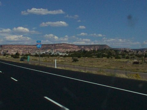1995 Ford C-350 (Centurion Conversions) - A view from a highway shows a sign for Exit 40 with a vast mountainous landscape in the background under a partly cloudy sky.
