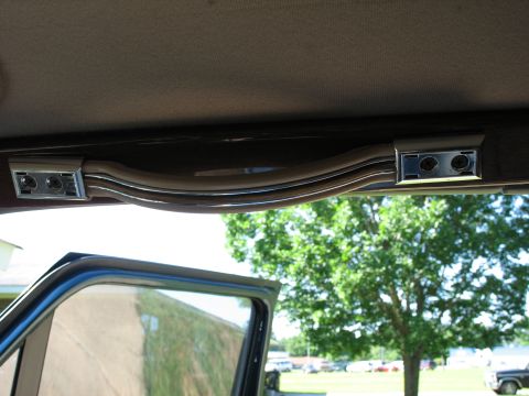 1995 Ford C-350 (Centurion Conversions) - Interior view of a vehicle's headliner trim, showing chrome accents and light switch controls.