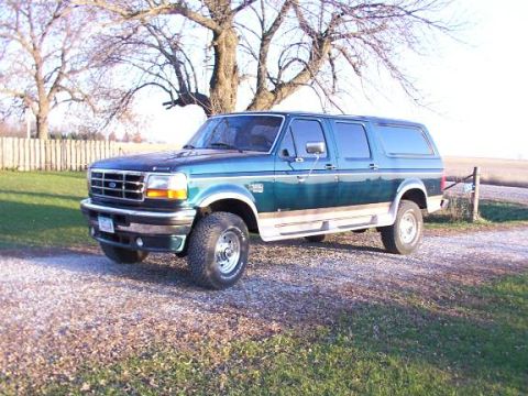 1995 Ford C-350 (Centurion Conversions) - This 1995 Ford C-350 Centurion Conversions SUV features a distinctive two-tone paint scheme with wood paneling accents.