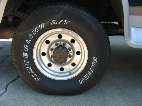 1995 Ford C-350 (Centurion Conversions) - A close-up view of a vehicle's wheel and tire, showing the brand names Timberline and Dayton.