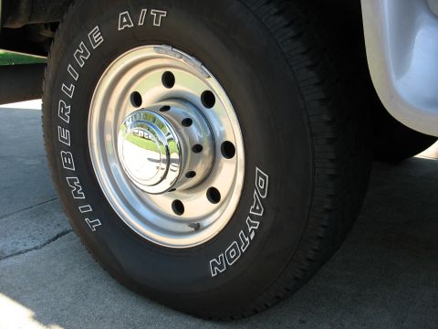1995 Ford C-350 (Centurion Conversions) - A close-up view focuses on the tire and wheel assembly of a large truck.