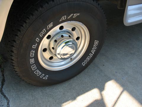 1995 Ford C-350 (Centurion Conversions) - A close-up view of a vehicle's wheel and tire, showing the brand names on the sidewall.