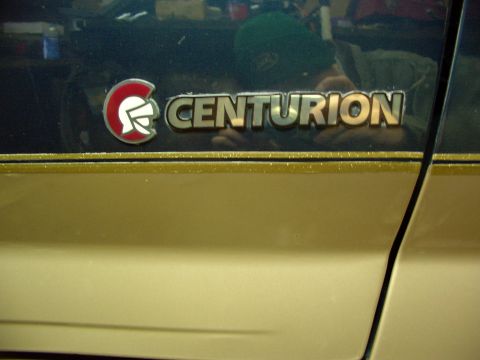 1995 Ford C-350 (Centurion Conversions) - Vehicle side panel displays a chrome Centurion badge with a red and white emblem.