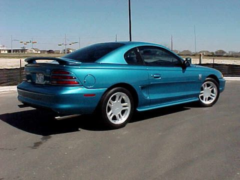 1994 Ford Mustang - This teal 1994 Ford Mustang coupe features a distinctive rear spoiler and a 3/4 front view.