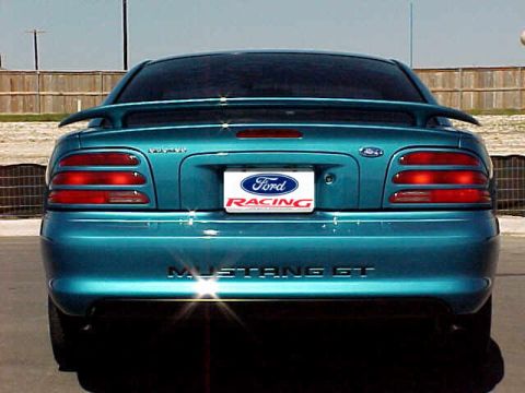 1994 Ford Mustang - The rear of a teal Ford Mustang GT shows its distinctive taillights and 'Mustang GT' badging.