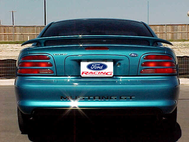 Teal Ford Mustang GT rear view with Ford Racing plate and spoiler