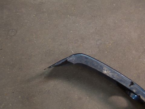 1995 Ford C-350 (Centurion Conversions) - Close-up of a damaged blue plastic automotive part, likely a bumper section.