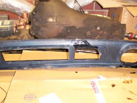 1995 Ford C-350 (Centurion Conversions) - Close-up of a dark blue automotive grille section, likely a front valance, with visible openings and residue.
