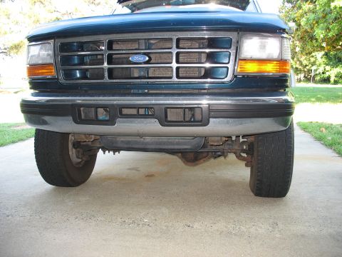 1995 Ford C-350 (Centurion Conversions) - Front view of a teal Ford truck, showing the grille, headlights, and bumper.