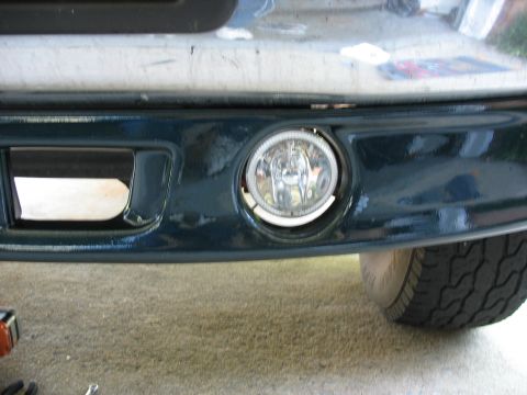 1995 Ford C-350 (Centurion Conversions) - Close-up of a vehicle's front valance, showing a fog light and vent detail.