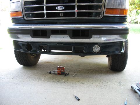 1995 Ford C-350 (Centurion Conversions) - Front view of a Ford truck, showing the grille and bumper with tools nearby.