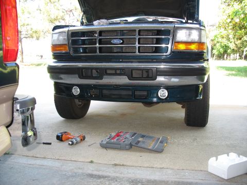 1995 Ford C-350 (Centurion Conversions) - Front valance of a 1995 Ford C-350 (Centurion Conversions) with fog lights, tools on the ground.