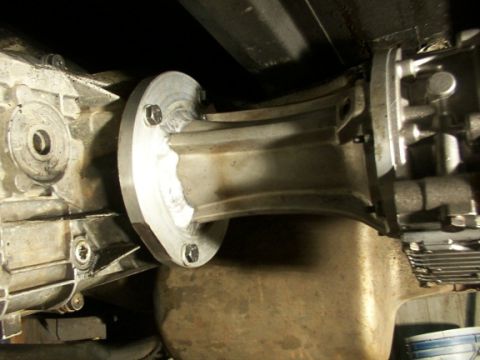 1995 Ford C-350 (Centurion Conversions) - Close-up view of a transmission adapter plate connecting two parts of a drivetrain.