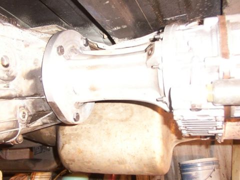 1995 Ford C-350 (Centurion Conversions) - Close-up of a vehicle's transmission adapter plate and oil pan, showing bolted connections.