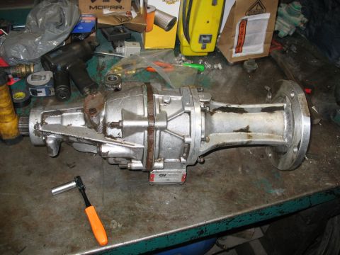 1995 Ford C-350 (Centurion Conversions) - A Gear Vendor overdrive unit is shown on a workbench, surrounded by various tools and parts.