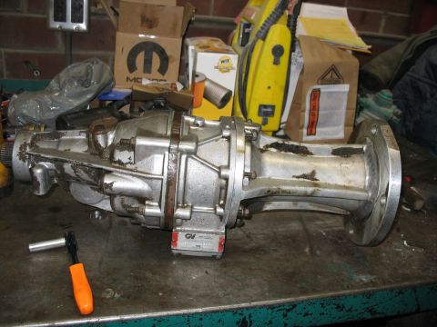 1995 Ford C-350 (Centurion Conversions) - A Gear vender overdrive unit is shown on a workbench, with a red label visible on its side.