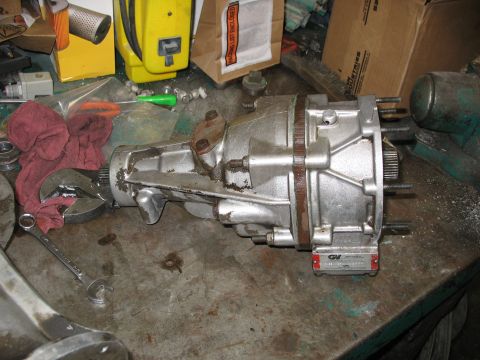 1995 Ford C-350 (Centurion Conversions) - A Gear Vendor overdrive unit is shown on a workbench, with tools and other parts in the background.