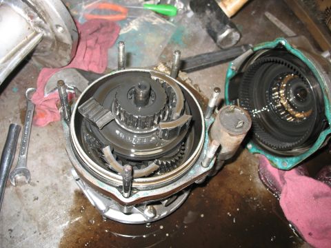 1995 Ford C-350 (Centurion Conversions) - Close-up of a disassembled transmission component, showing internal gears and fluid.