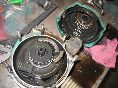 1995 Ford C-350 (Centurion Conversions) - Close-up of a disassembled transmission component, showing internal gears and lubrication.