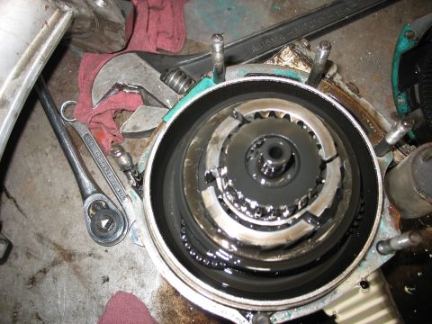 1995 Ford C-350 (Centurion Conversions) - A close-up view of a disassembled vehicle transmission part, showing internal gears and lubrication.