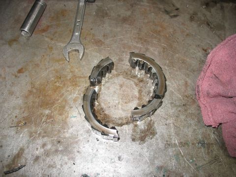 1995 Ford C-350 (Centurion Conversions) - A broken gear part lies on a workbench next to a wrench and socket, suggesting a mechanical repair.