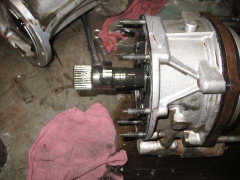 1995 Ford C-350 (Centurion Conversions) - Close-up of a transmission output shaft and housing, with a pink rag nearby. No vehicle is visible.