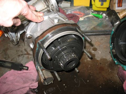 1995 Ford C-350 (Centurion Conversions) - Disassembled transmission components, including gears and housing, are visible on a cluttered workbench.