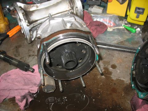 1995 Ford C-350 (Centurion Conversions) - Disassembled transmission or transfer case part with visible splines, likely undergoing maintenance or repair.