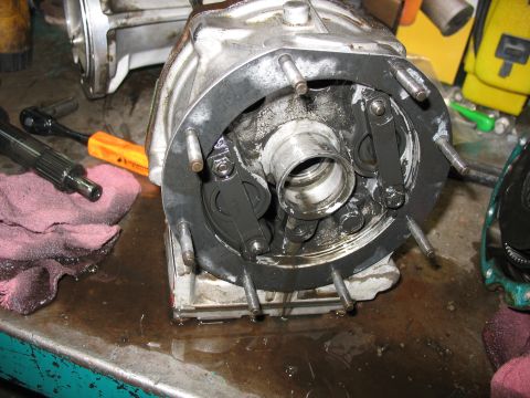 1995 Ford C-350 (Centurion Conversions) - Close-up of a disassembled transmission part, showing internal mechanisms on a workbench.