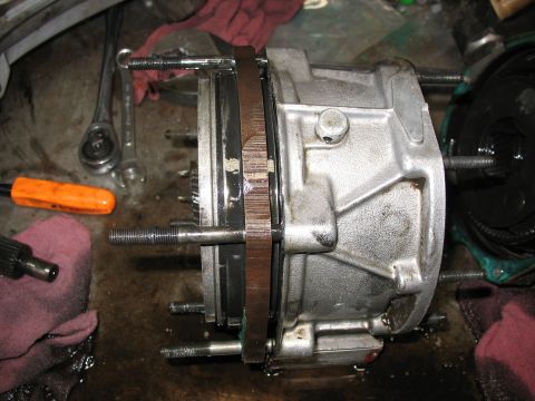 1995 Ford C-350 (Centurion Conversions) - Transmission component with visible bolts and a ring, likely undergoing repair or maintenance.
