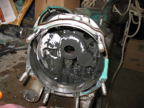 1995 Ford C-350 (Centurion Conversions) - Close-up of a disassembled transmission housing, showing internal gears and grease, secured in a vise.
