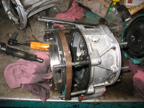 1995 Ford C-350 (Centurion Conversions) - Close-up of a disassembled transmission or transfer case part, with tools and rags visible.