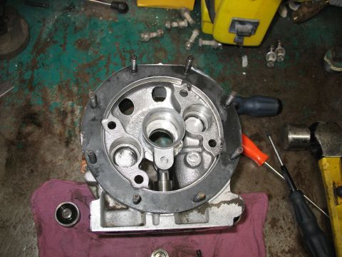 1995 Ford C-350 (Centurion Conversions) - A disassembled Gear Vendor overdrive unit is shown on a workbench with various tools nearby, suggesting maintenance or repair.