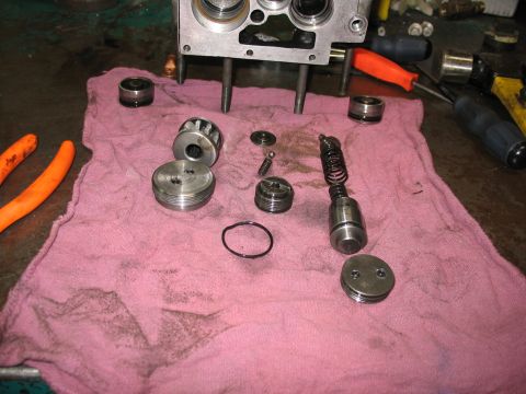 1995 Ford C-350 (Centurion Conversions) - Disassembled hydraulic valve body and its components are spread out on a pink shop towel, with tools visible in the background.