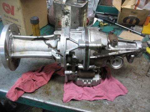 1995 Ford C-350 (Centurion Conversions) - A Gear Vendors overdrive unit is shown on a workbench, with a metal can and a box with the GVI logo in the background.