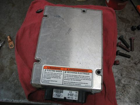 1995 Ford C-350 (Centurion Conversions) - This Ford electronic control module features warning labels about high voltage and a part number visible on the connector.