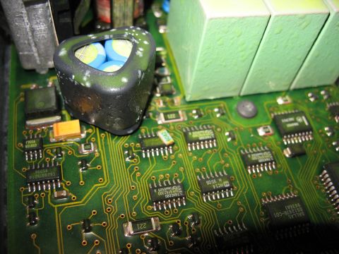 1995 Ford C-350 (Centurion Conversions) - Close-up of a green circuit board a triangular capacitor and multiple integrated circuits.