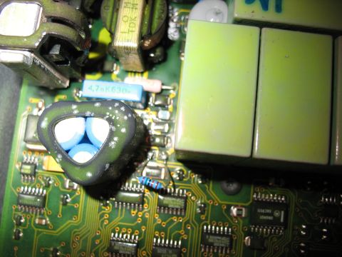 1995 Ford C-350 (Centurion Conversions) - A detailed view of electronic components on a circuit board, a distinctive triangular capacitor.