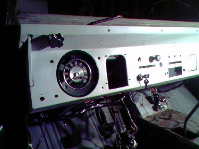 Vehicle dashboard with gauge cluster and exposed wiring