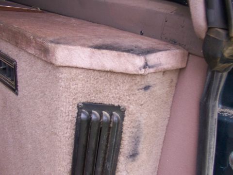 1995 Ford C-350 (Centurion Conversions) - Close-up of a worn vehicle interior panel with visible vents and dark marks.